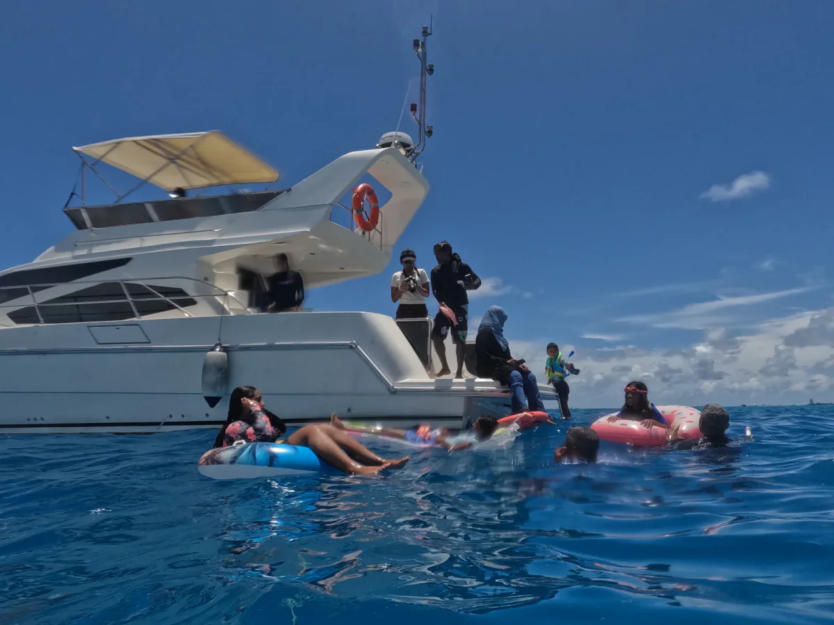 Guests boarding Tiffany Blanc 14 from the water at the stern
